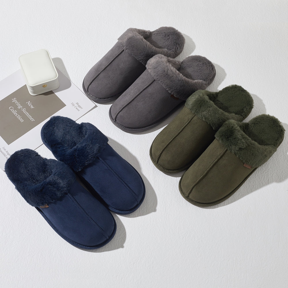 Three pairs of men's slip-on slippers with plush faux-fur trim, arranged on a white surface. The slippers come in navy blue, dark gray, and olive green, with two pairs overlapping near the top and two pairs near the bottom.
